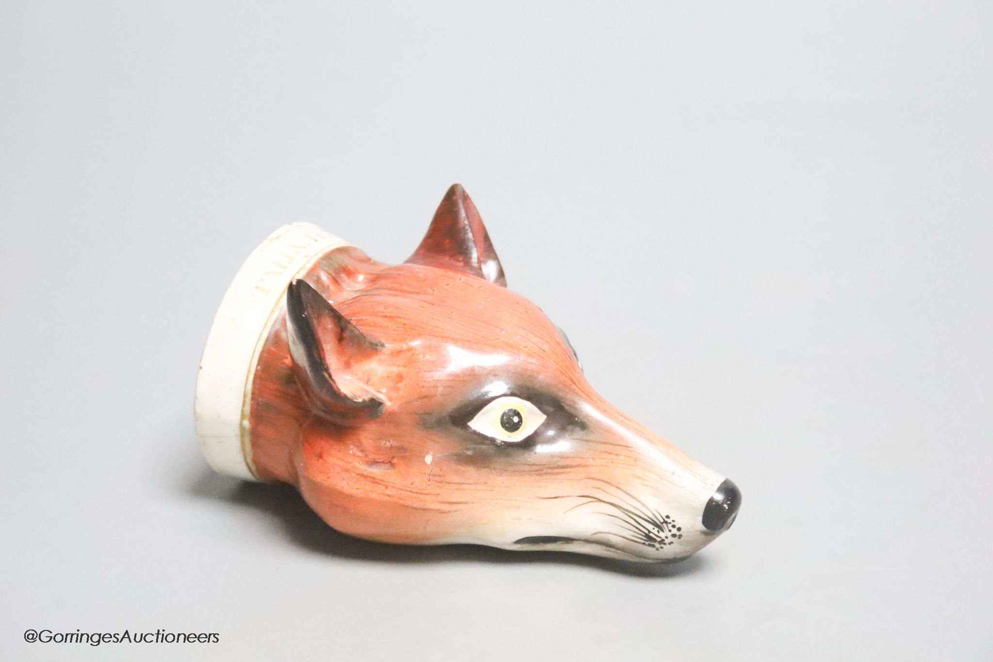 An early 19th century English porcelain 'Tally Ho' fox head stirrup cup, length 11cm